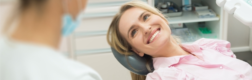 patient smiling with her dentists