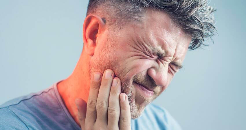 A Man Suffering From Tooth Pain